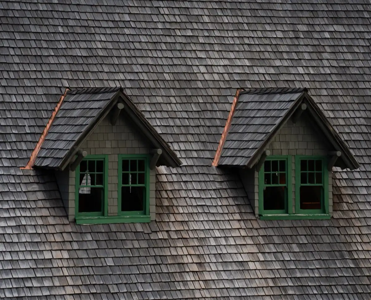 Dormers on a shingle roof in Clifton, NJ, where step flashing and kickout flashing carry water past the walls